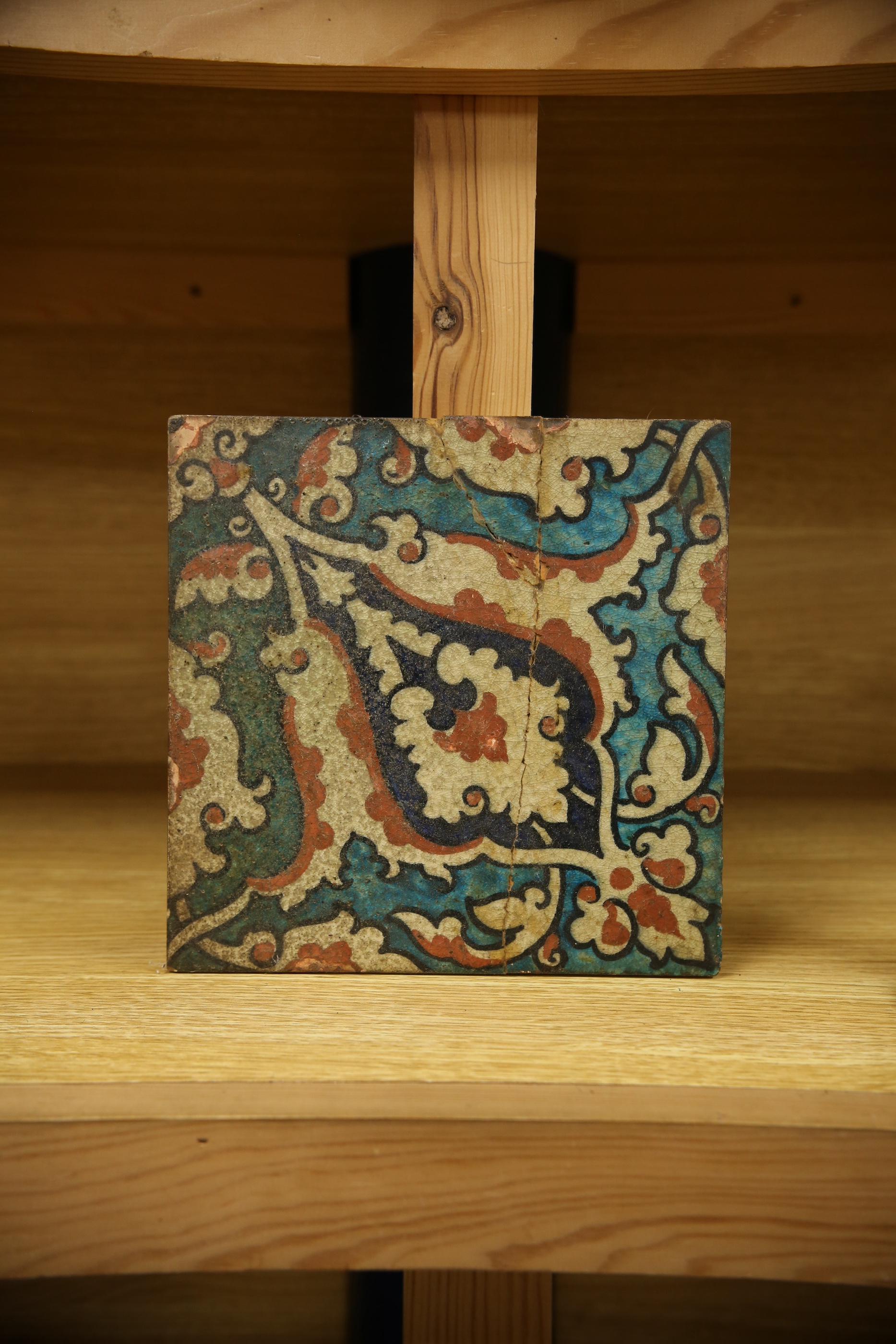 A 17th century style Iznik pottery tile, 20.5cm sq. Condition - poor